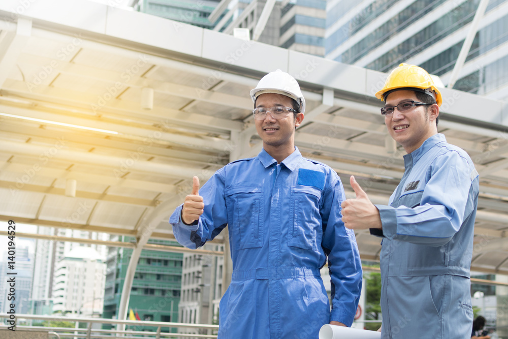 Engineer and Architect working at Construction Site with blueprint Engineer and Architect working at Construction Site with blueprint