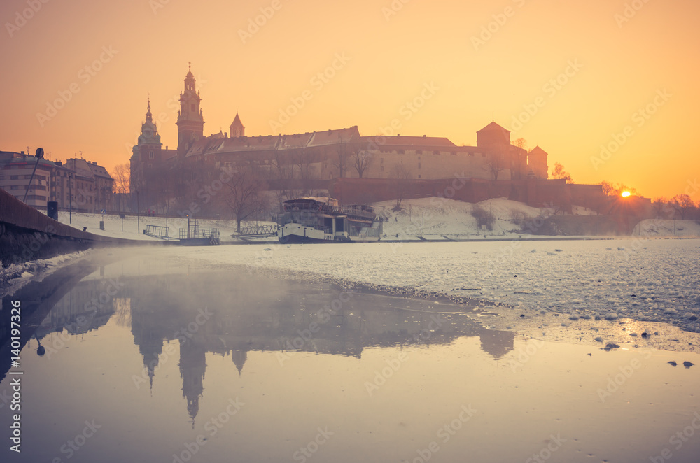 Krakow, Poland, Wawel Castle and Wawel cathedral in the winter over frozen Vistula river in the morning