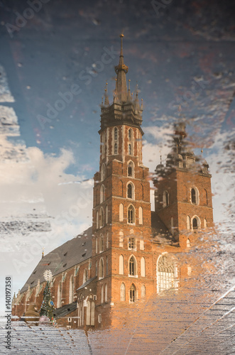Krakow, Poland, St Mary's church reflecting in puddle after rain