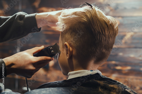 Little Boy Getting Haircut By Barber  