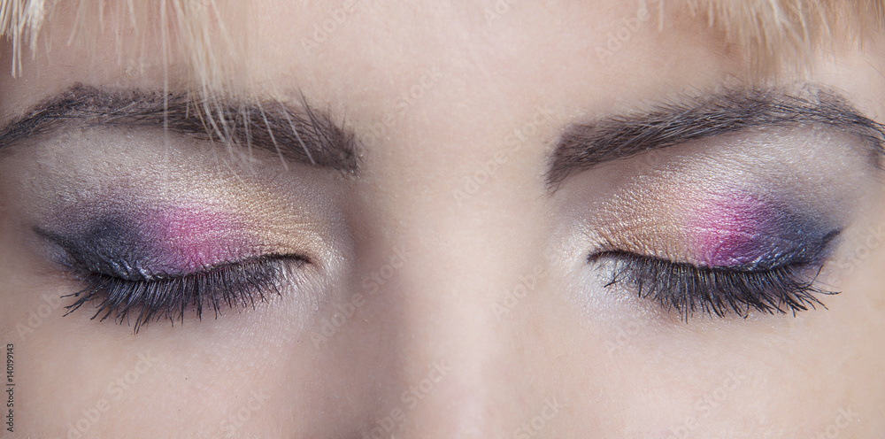 Naklejka premium cocktail makeup closeup on closed eyes girl with clean skin. Three colors. Macro.