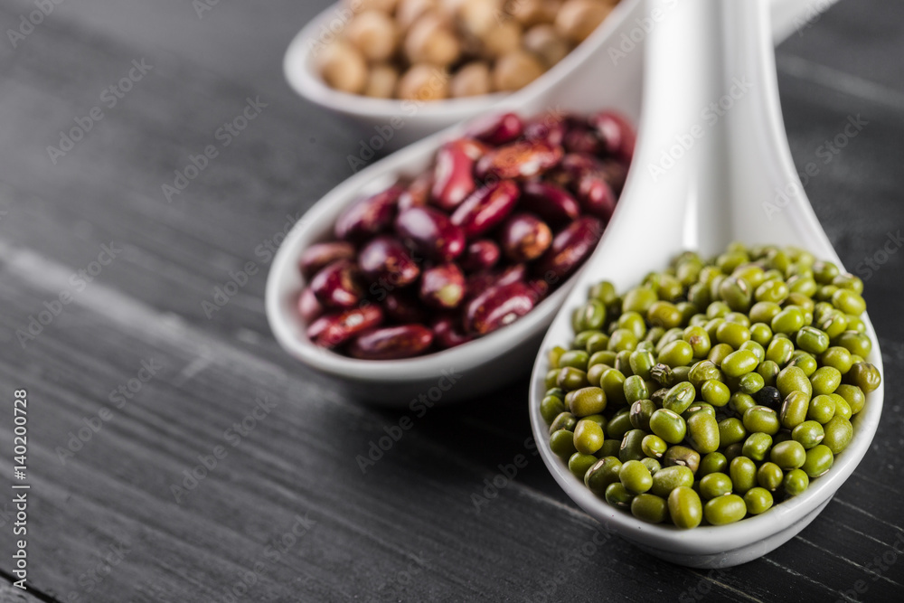 mix of beans on wooden table mix of beans on wooden table