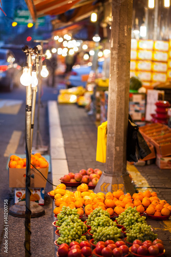 Night fruit store on the sidewalk