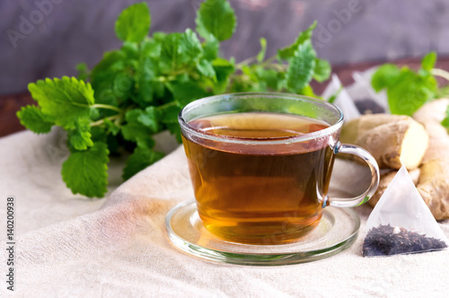 Cup with black tea Fresh mint Honey Ginger