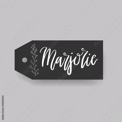 Common female first name Marjorie on a tag. Hand drawn calligraphy. Wedding typography element.