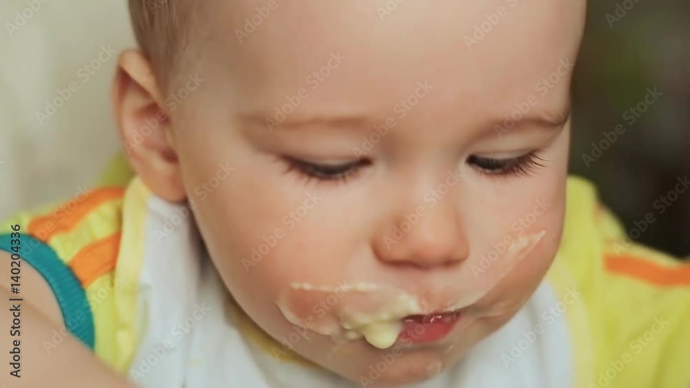 Mother feeds her child. Face close-up. Mother feeds her child. Face close-up.