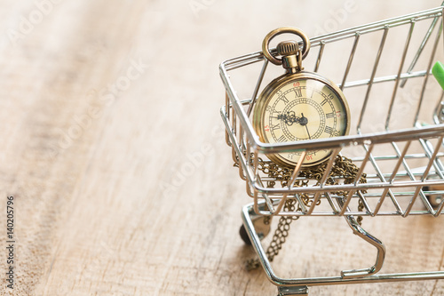 miniature pocket clock in shopping cart photo