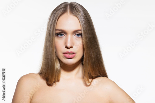 Blonde model woman with long shiny hair and healthy skin on white background