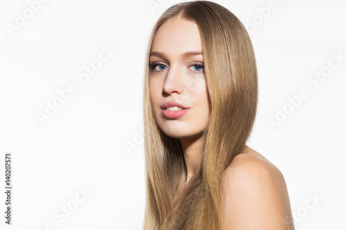 Beauty portrait of blonde smiling model woman with long shiny hair and healthy skin looking at camera on white background
