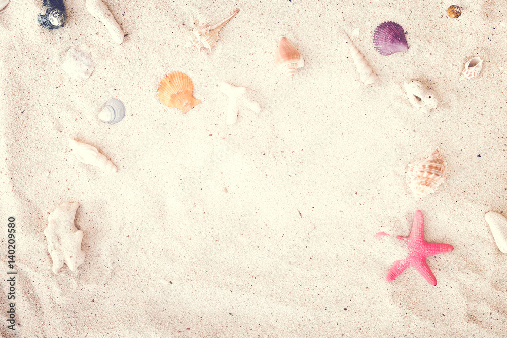 Top view of Beach sand with shells and starfish. summer background concept. vintage tone.