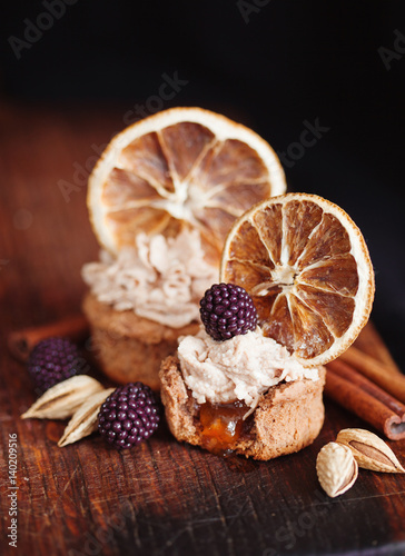 almond and orange cupcake with fresh blackberry