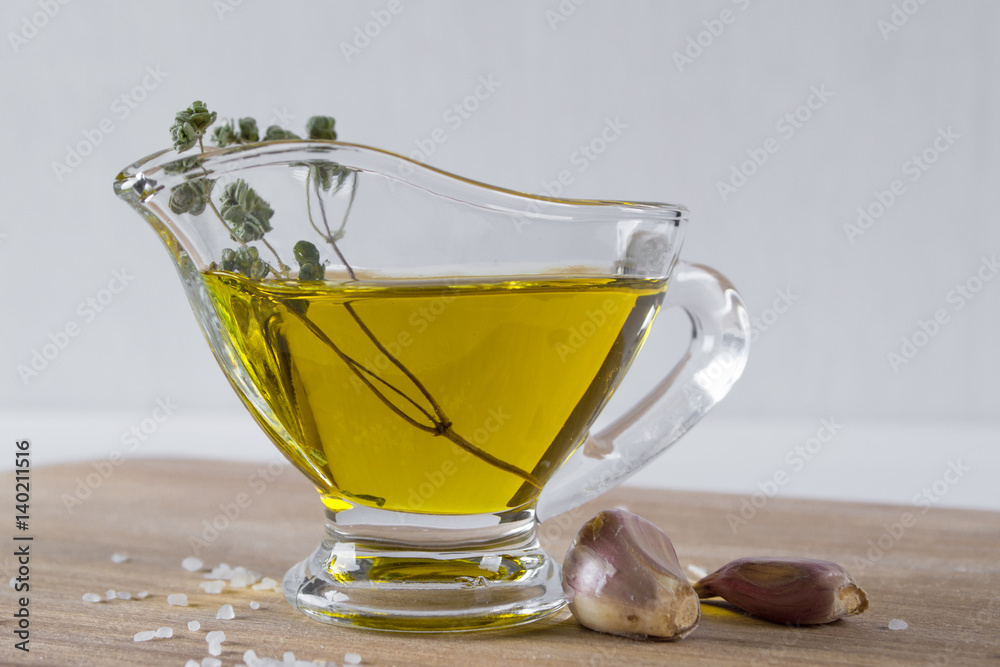 Olive oil with herb spicy ,garlic and sea salt on wooden background Olive oil with herb spicy ,garlic and sea salt on wooden background
