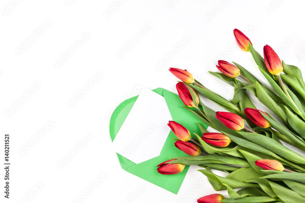 Beautiful tulip bouquet and green envelope with card on white background Beautiful tulip bouquet and green envelope with card on white background