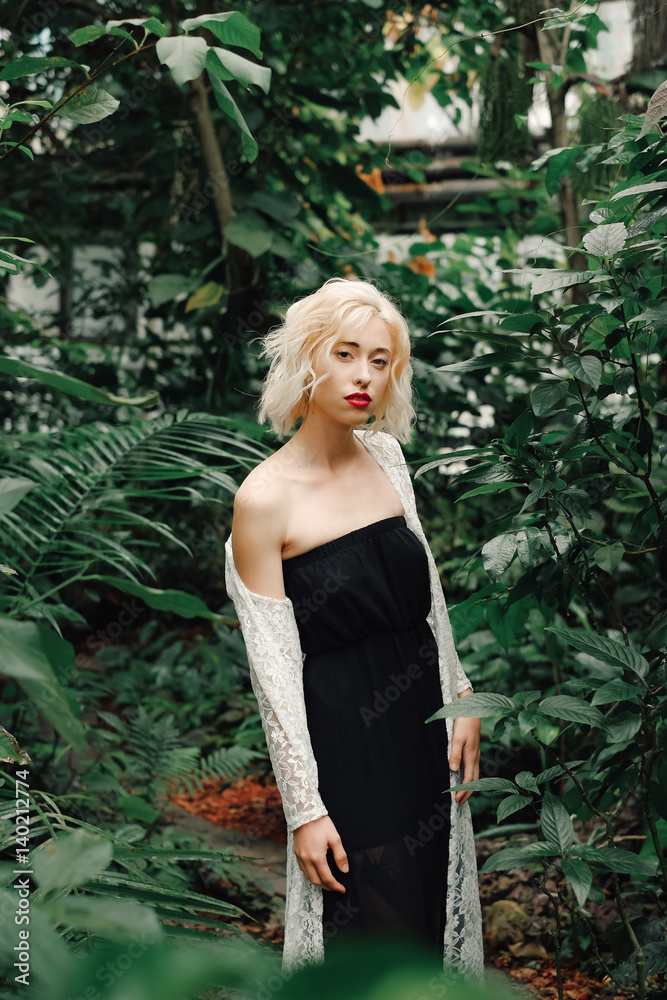 Fashion model posing in tropical botanic garden Fashion model posing in tropical botanic garden