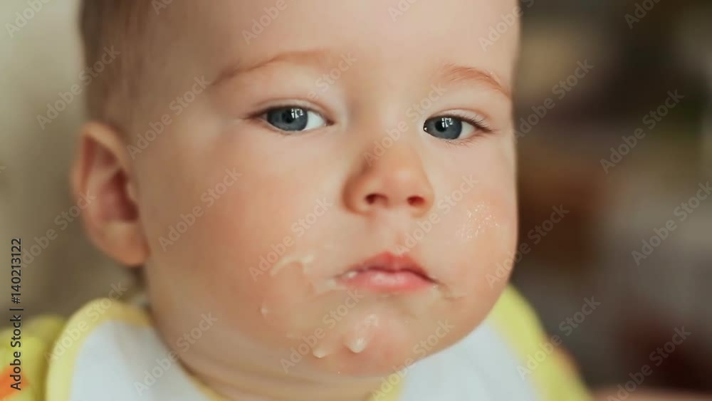 Mother feeds her capricious child. Face close-up. Mother feeds her capricious child. Face close-up.