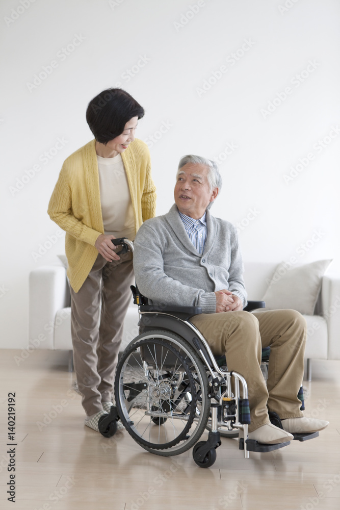 Senior man in wheelchair and senior woman Senior man in wheelchair and senior woman