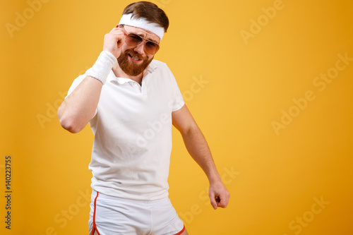 Cool sportsman in sunglasses looking at camera