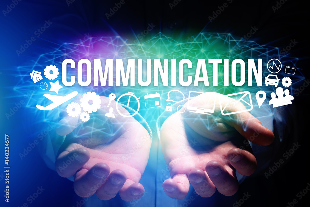 Concept of man holding a futuristic interface with communication title and multimedia icons flying all around - Internet concept Concept of man holding a futuristic interface with communication title and multimedia icons flying all around - Internet concept