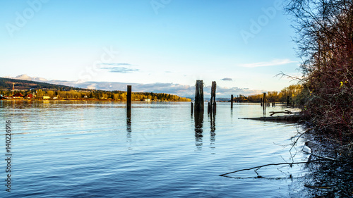 Sunset over the quiet waters of the Fraser River near Fort Langley in the Middle of Winter under blue sky © hpbfotos