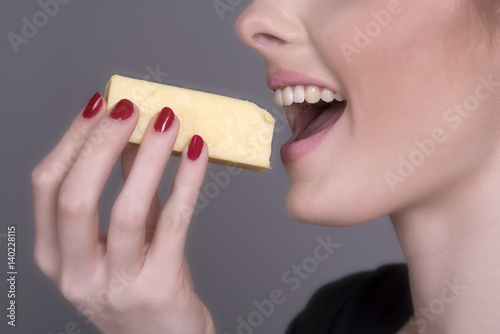 Woman eating a chunk of Cheese