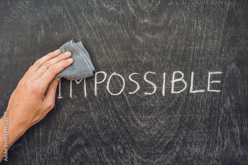 Making the impossible possible concept on blackboard background photo