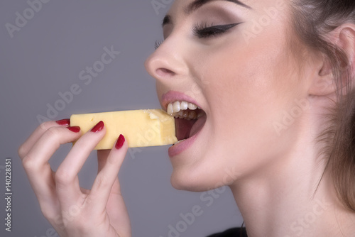 Woman eating a piece of Cheese
