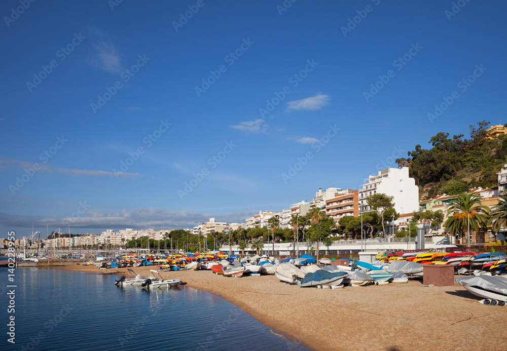Blanes Beach With Motorboats and Kayaks on Costa Brava in Spain