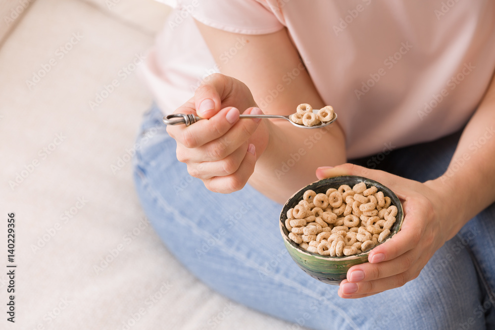 Closeup of woman's hands holding bowl with organic whole wheat cereal. Healthy Breakfast or snack. Healthy food and eating. Closeup of woman's hands holding bowl with organic whole wheat cereal. Healthy Breakfast or snack. Healthy food and eating.