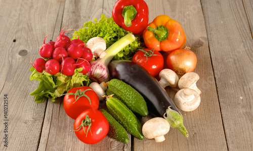 Composition with assorted raw organic vegetables wooden table