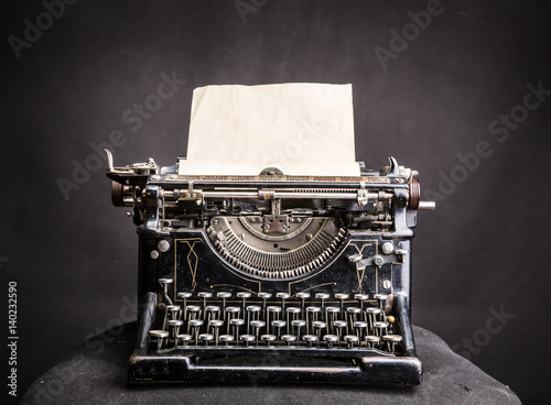 Vintage black typewrite with inserted paper sheet