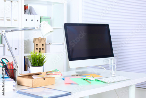 A note book, laptop, pen, graph paper document on the office desk table behind white blind © lenetsnikolai