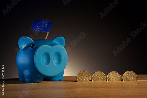 piggy bank on a wooden base wiih money photo
