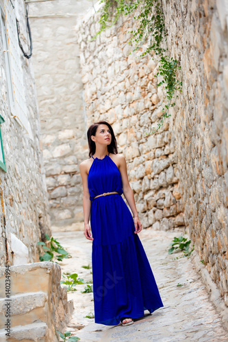 photo of beautiful young woman standing in the middle of the street in Greece © Masson