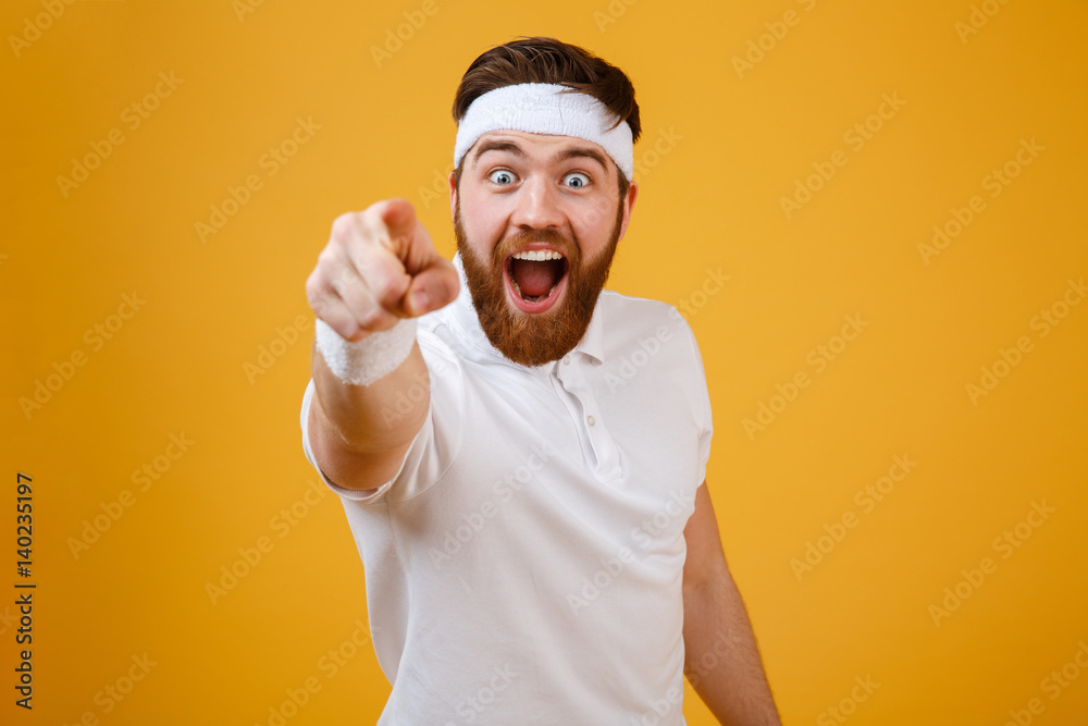Happy bearded sportsman pointing at camera Happy bearded sportsman pointing at camera