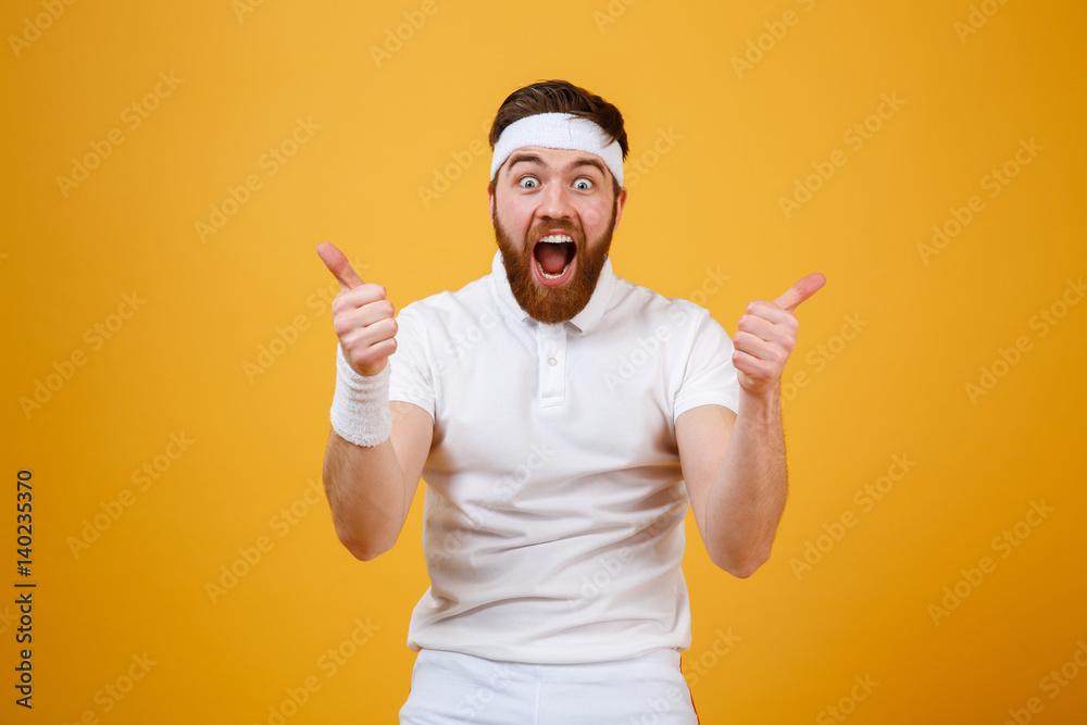 Screaming bearded sportsman showing thumbs up Screaming bearded sportsman showing thumbs up