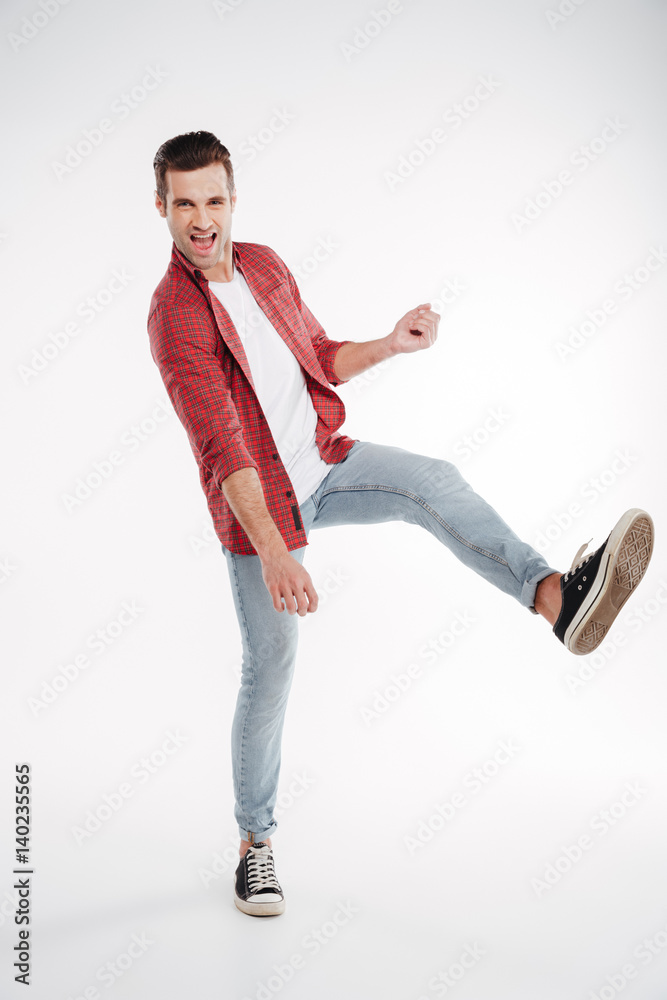 Naklejka premium Vertical image of man playing on imaginary guitar