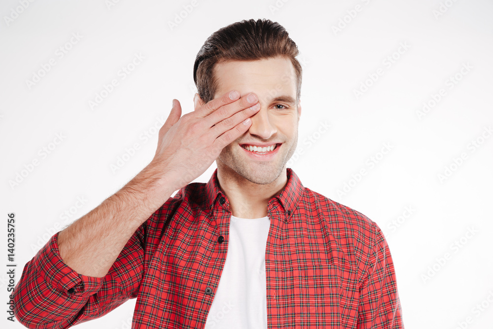 Smiling Man covering one eye Smiling Man covering one eye