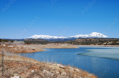 Abajo Mountains and winter lake in Utah