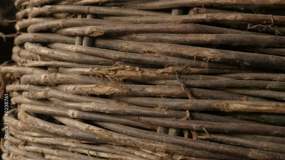 Slow tilt on old wicker basket handwork texture 4K 2160p 30fps UltraHD footage - Details of coiled container