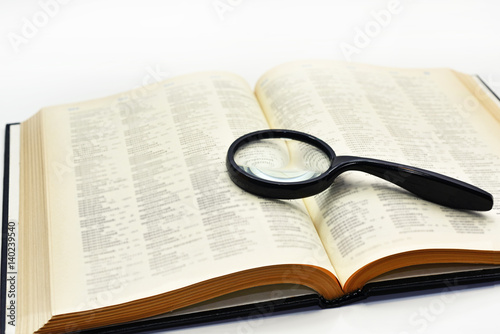 Old books with magnifying glass.