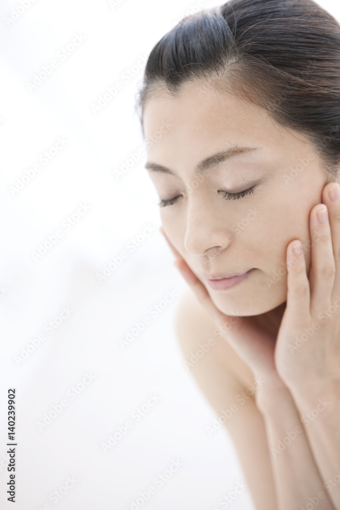 Mature Woman Touching Her Face with Eyes Closed Mature Woman Touching Her Face with Eyes Closed