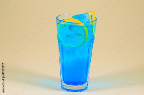 Colorful fruit cocktail on neutral background.