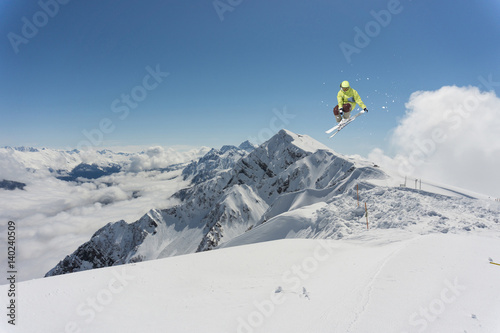 Flying skier on mountains. Extreme winter sport.