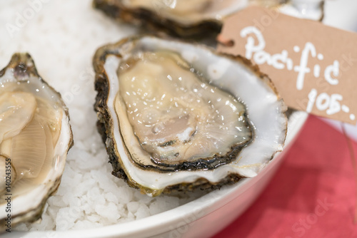 Fresh oysters platter with sauce and lemon