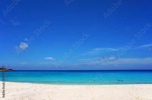 Scenic seascape of azure transparent ocean water and blue sky. Tropical beach with white sand. Idyllic scenery of seaside resort. Exotic travel destination for holiday and vacation