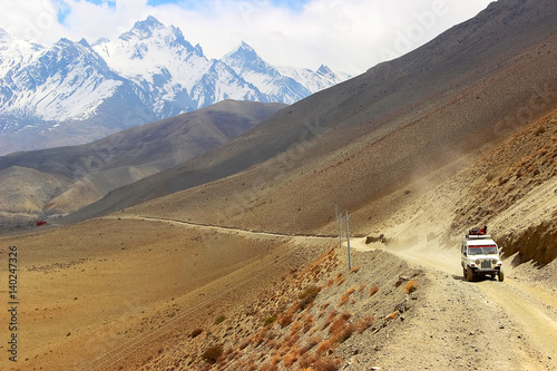 A car with tourists on a mountain road in the Himalayan mountains. Nepal. The kingdom of 