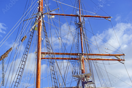 Nautical maritime scene with ropes and mast on a ship on a dock by the water