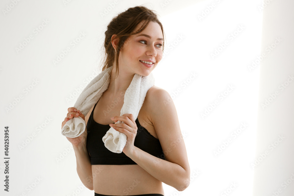 Attractive young woman standing with fresh towel on her shoulders Attractive young woman standing with fresh towel on her shoulders