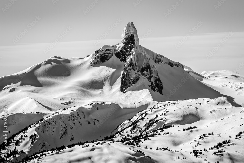 The distinctive peak of The Black tusk mountain in Black and White from the summit of Whistler mountain in winter
