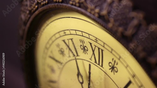 An old antique bronze clock ticks slowly by